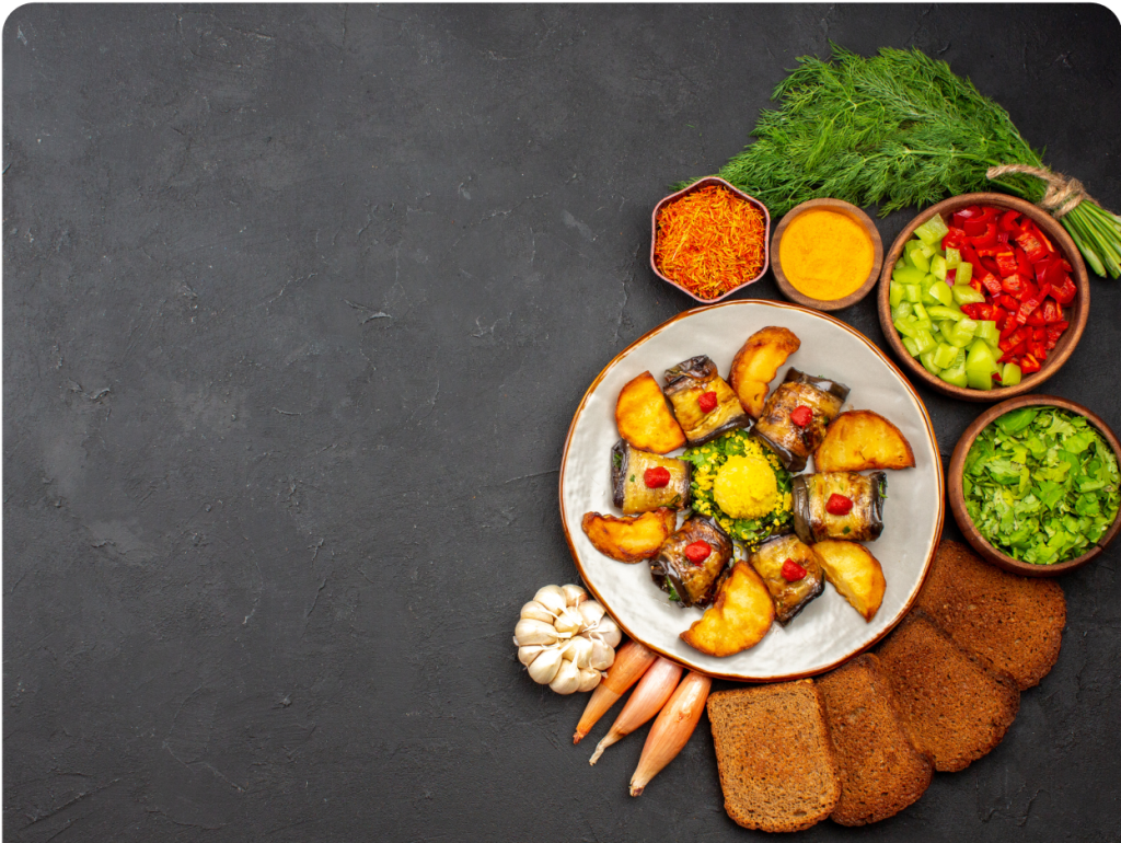Top view of delicious eggplant rolls with potatoes and bread loaves on a dark background